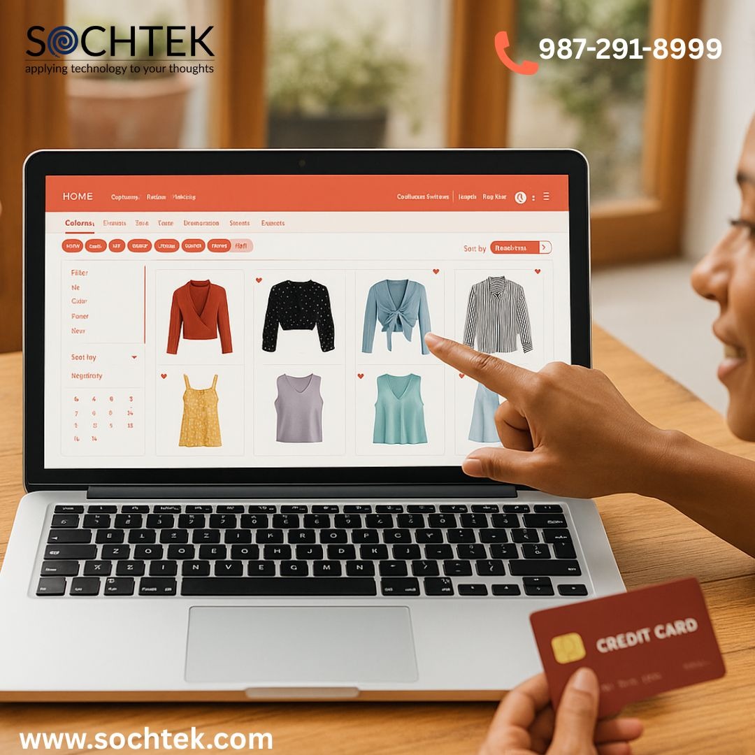 Two women shopping online for clothes using a laptop, with one pointing at the screen and the other holding a credit card.